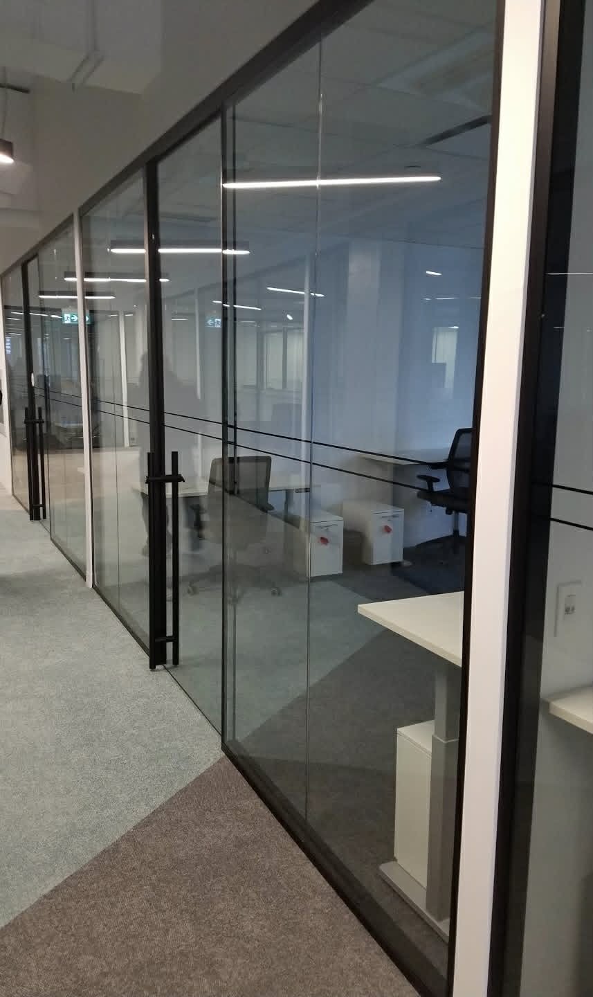 Glass office partitions with black frames installed by SOIS